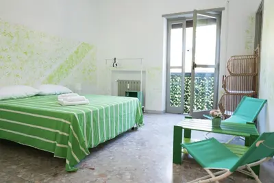 a bedroom with a bed and two chairs and a table at Next Stop Roma Affittacamere Da Florindo in Rome