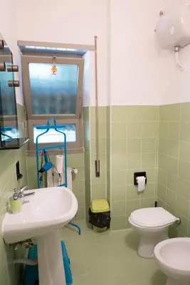 a bathroom with a white sink and a toilet at Next Stop Roma Affittacamere Da Florindo in Rome