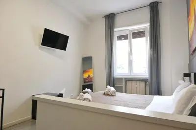 a bedroom with a bed with two stuffed animals on it at Vatican Central Suites in Rome