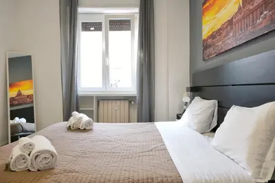 a bedroom with a large bed with towels on it at Vatican Central Suites in Rome