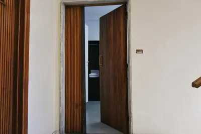 a wooden door in a room with a mirror at Vatican Central Suites in Rome