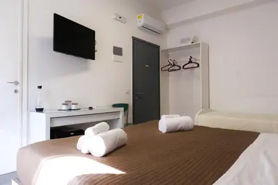 a bedroom with a bed with towels on it at Vatican Central Suites in Rome