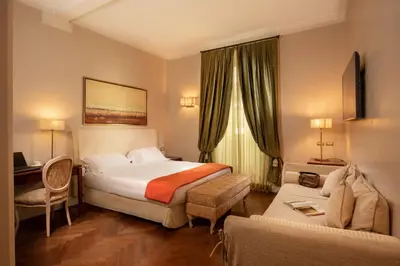 a hotel room with a bed and a couch at Vivaldi Luxury Rooms in Rome