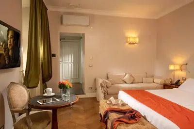a hotel room with a bed and a couch at Vivaldi Luxury Rooms in Rome