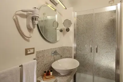 a bathroom with a sink and a shower at Vivaldi Luxury Rooms in Rome