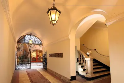 a hallway with a staircase and a chandelier at Vivaldi Luxury Rooms in Rome