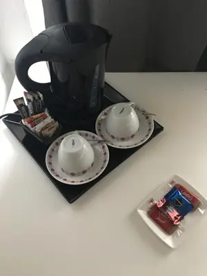 a black tea pot and two plates on a table at Domum Vaticani in Rome