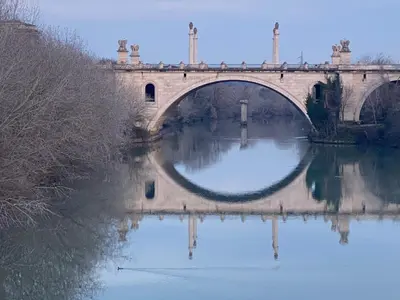 a bridge over a river with reflections in the water at Domum Vaticani in Rome