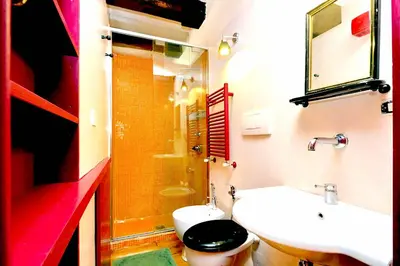 a bathroom with a toilet and a sink and a shower at delCINQUE 26 - Loft in Trastevere in Rome