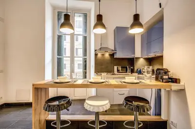 a kitchen with a large island with stools in it at Cavour Colloseum suite in Rome