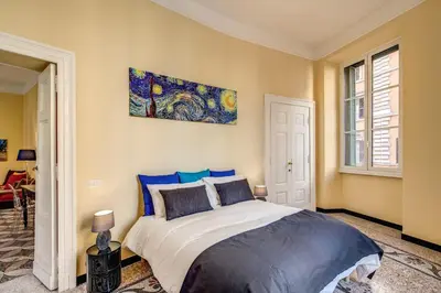 a bedroom with a bed and a painting on the wall at Cavour Colloseum suite in Rome