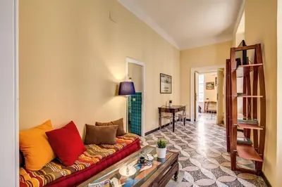 a living room with a couch and a table at Cavour Colloseum suite in Rome