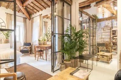 a room with a bed and a table with plants at Loft&Terrace - Elevated Elegance at Navona in Rome