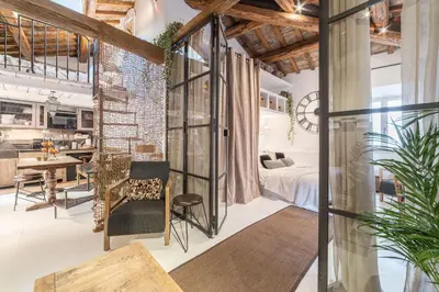 a room with a bed and a dining room at Loft&Terrace - Elevated Elegance at Navona in Rome