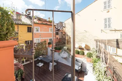 a balcony with a table and chairs and buildings at Loft&Terrace - Elevated Elegance at Navona in Rome