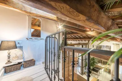 a staircase in a house with wooden ceilings at Loft&Terrace - Elevated Elegance at Navona in Rome