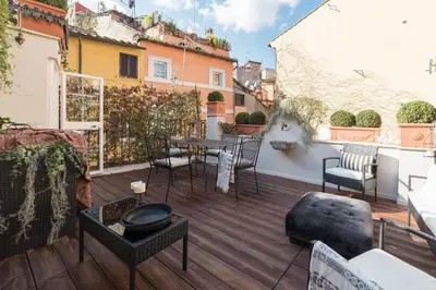 a patio with a table and chairs on a balcony at Loft&Terrace - Elevated Elegance at Navona in Rome