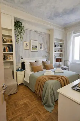 a bedroom with a large bed with a window at Suites Piazza Del Popolo in Rome