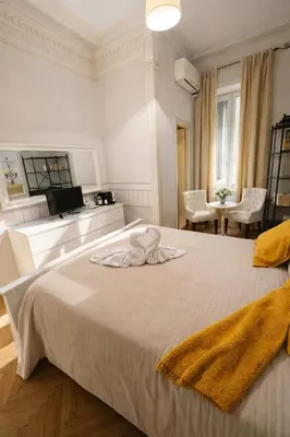 a bedroom with two beds and a chandelier at Suites Piazza Del Popolo in Rome