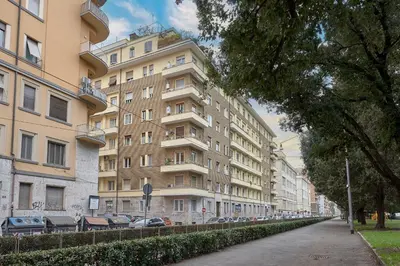 a large building with cars parked in front of it at Suites Piazza Del Popolo in Rome