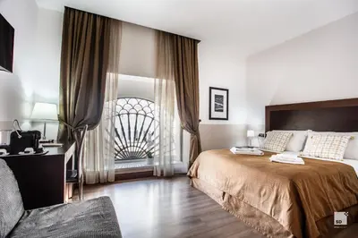 a bedroom with a large bed and a window at Hotel Boutique Nazionale in Rome