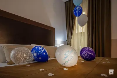 a group of blue and white balloons on a bed at Hotel Boutique Nazionale in Rome