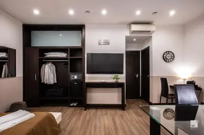 a hotel room with a bed and a desk and a television at Hotel Boutique Nazionale in Rome