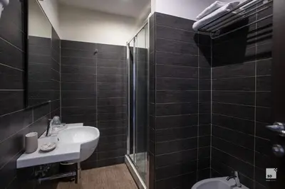 a bathroom with a sink and a shower at Hotel Boutique Nazionale in Rome