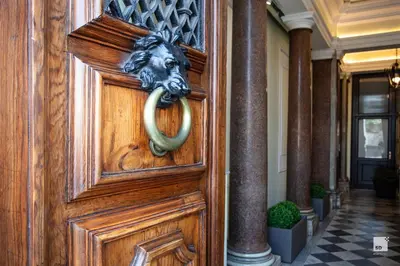 a wooden door with a lion head knocker on it at Hotel Boutique Nazionale in Rome