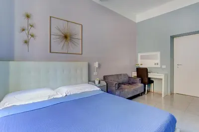 a bedroom with a bed and a large window at Holiday Sunny Roma B&B in Rome