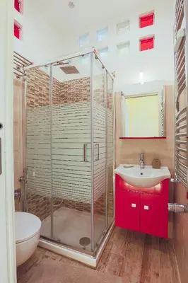 a bathroom with a glass shower and a sink at Vatican Garden in Rome