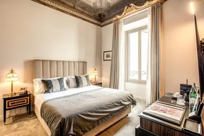 a bedroom with a large bed and a window at Martius Private Suites Hotel in Rome