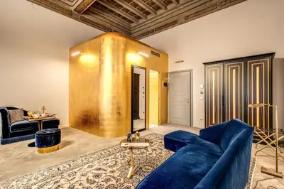 a living room with a blue couch and a table at Martius Private Suites Hotel in Rome