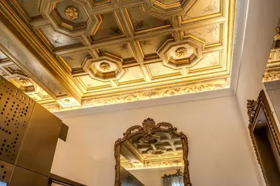 a ceiling in a hallway with a mirror at Martius Private Suites Hotel in Rome