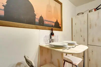 a table with two plates and a bottle of wine at Il Nido in Rome