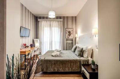a small room with a bed and a desk in it at Santamaggiore in Rome