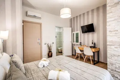 a bedroom with a bed with two towels on it at Santamaggiore in Rome