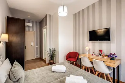 a room with a dining table and a red chair at Santamaggiore in Rome
