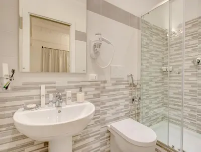 a bathroom with a sink and a toilet and a shower at Roma Suites Navona in Rome