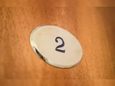 a button with the number two on a wooden door at Roma Suites Navona in Rome