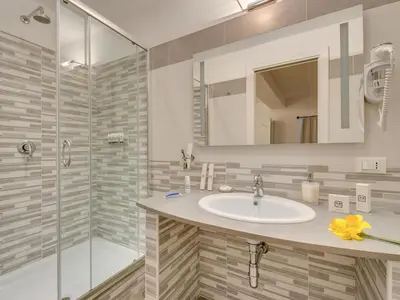 a bathroom with a sink and a shower at Roma Suites Navona in Rome
