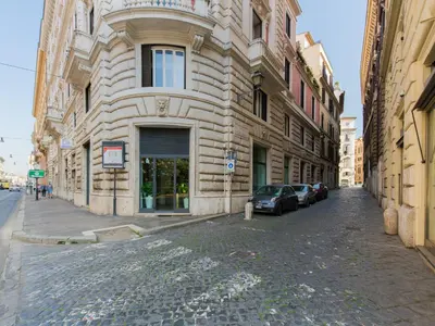 a stone building with a car parked next to a street at Roma Suites Navona in Rome