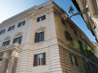 a tall brick building with windows on the side of it at Roma Suites Navona in Rome