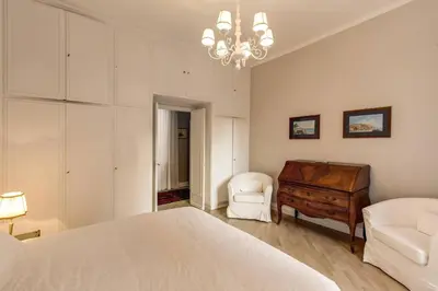 a bedroom with a bed and a dresser and a chair at Lovely Flat by the Vatican in Rome