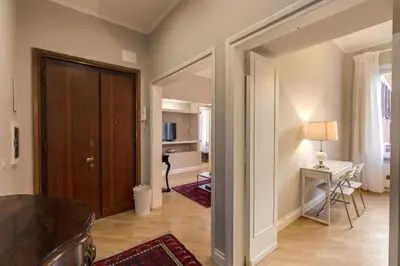 a living room with a door leading to a kitchen at Lovely Flat by the Vatican in Rome