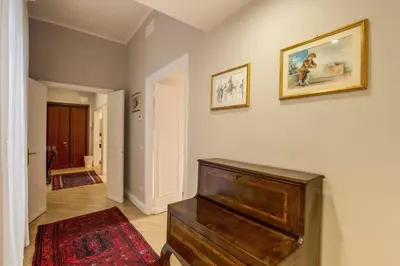 a living room with a piano and paintings on the wall at Lovely Flat by the Vatican in Rome