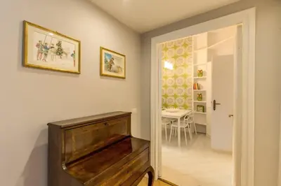 a piano in a room with a table at Lovely Flat by the Vatican in Rome