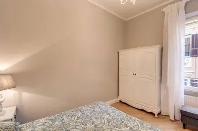 a bedroom with a bed and a cabinet and a window at Lovely Flat by the Vatican in Rome