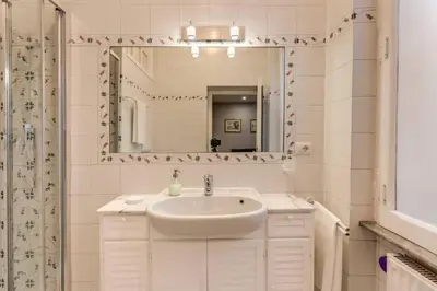 a white bathroom with a sink and a mirror at Lovely Flat by the Vatican in Rome