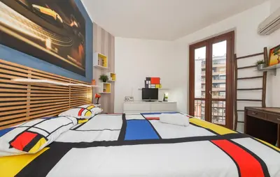 a bedroom with a large bed with a painting on the wall at Mondrian House in Rome